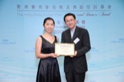 Mr Frank LEE, Chairman of The Hong Kong Jockey Club Music and Dance Fund, awarded a music scholarship to Miss Melodic CHAU